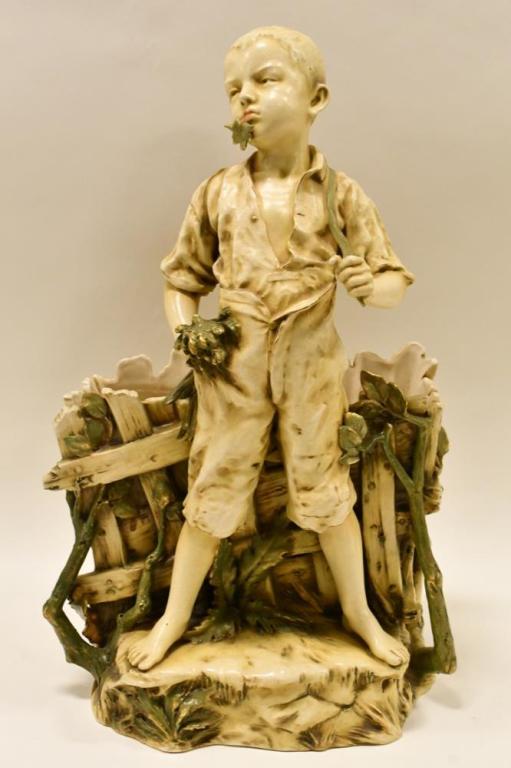Teplitz Amphora Austria RStK Figural Vase: Beautiful late 19th century Teplitz Amphora Austria RStK porcelain figural vase featuring a boy pulling his suspenders. The figural vase stands 20" tall and is in nice condition, has all over crazing.
