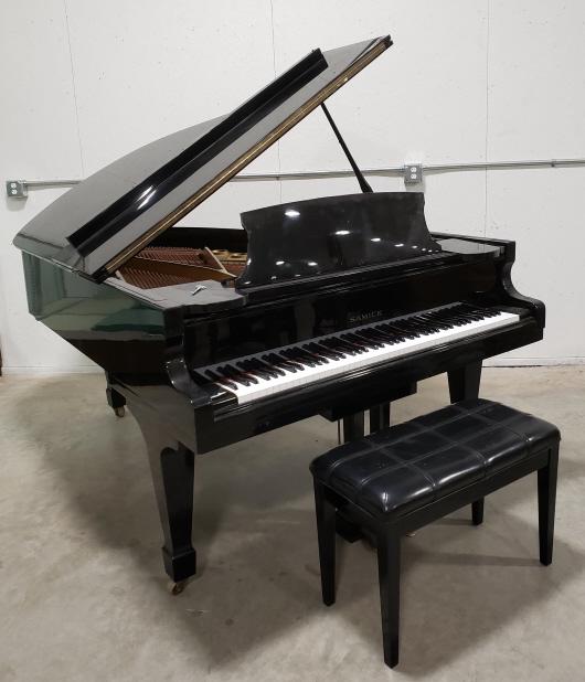 Samick Model G5A Grand Piano: 1980's Samick Model G5A Grand Piano. Serial #832007. Nice condition with wear from use and age. Displays well with ebony finish and stool. Measures approximately 5 foot 7 inches.