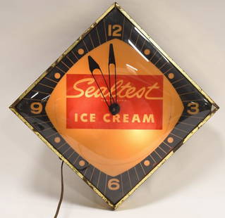 Vintage Sealtest Ice Cream Lighted Adv Clock: Vintage Sealtest Ice Cream lighted advertising clock. Clock is in good condition with yellowing and wear from use and age. .Clock lights up and appears to run (second hand is loose). Displays well wit