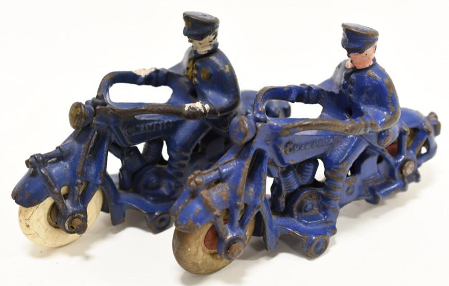 (2) 1930s Cast Iron Champion Motorcycles w Riders: Nice lot of two 1930s cast iron Champion Motorcycles with riders. Both are in nice condition with paitn loss and wear from use and age. Both display very well with white rubber wheels.