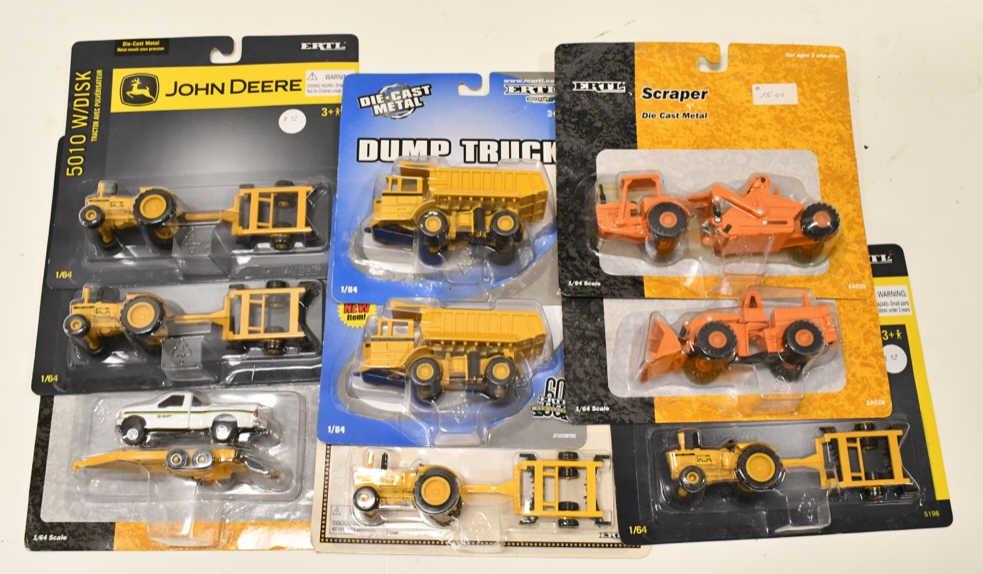 1/64 Ertl Industrial Tractors, Dump Trucks, Loader: 1/64 scale Ertl Industrial John Deere tractors with disks, dump trucks, loader, scraper, and more. Nice condition in the packages.