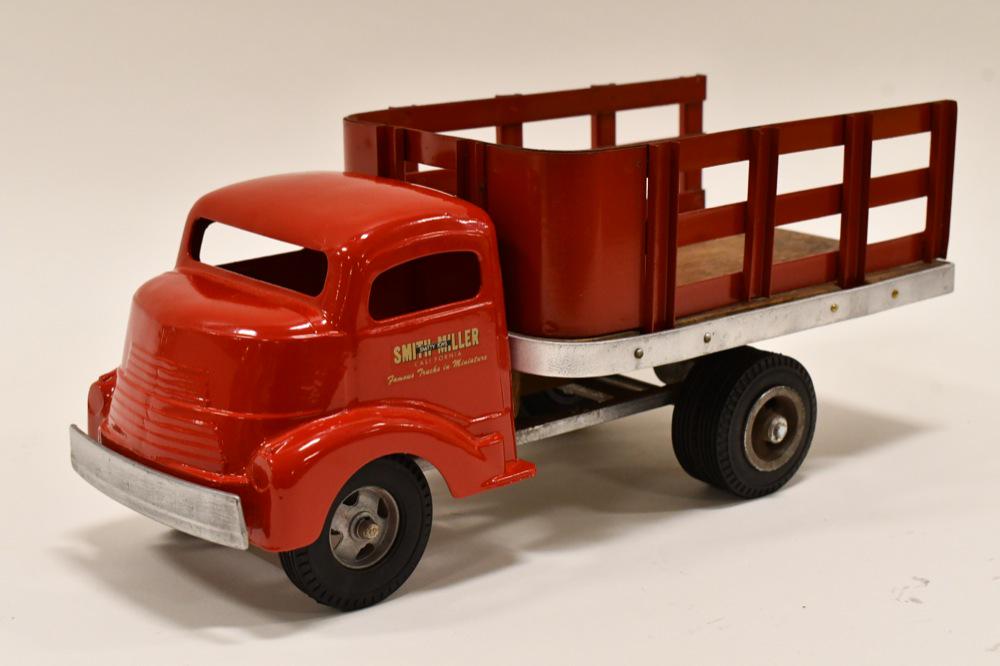 Restored Smith Miller GMC Stake Bed Truck: Restored Smith Miller GMC stake bed trailer. Displays nicely with some wear from storage and display. Measures approximately 14" long.