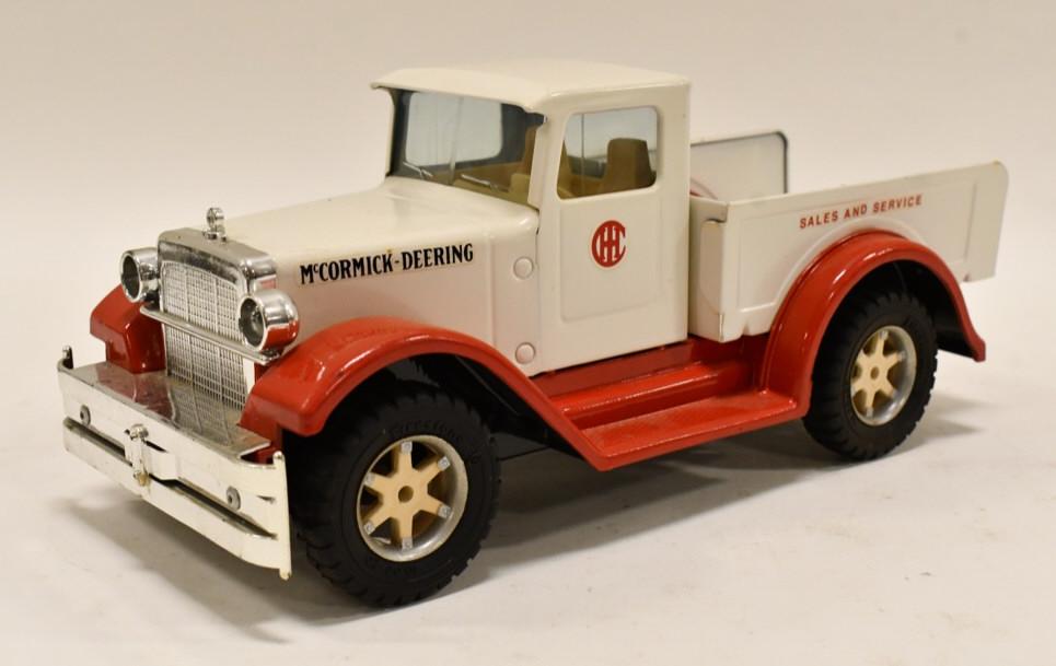 Custom Nylint McCormick-Deering Dealer Truck: Custom Nylint McCormick-Deering sales and service dealer pickup truck. Displays well with custom McCormick-Deering decals, and Firestone tires. Measures approximately 12" long.