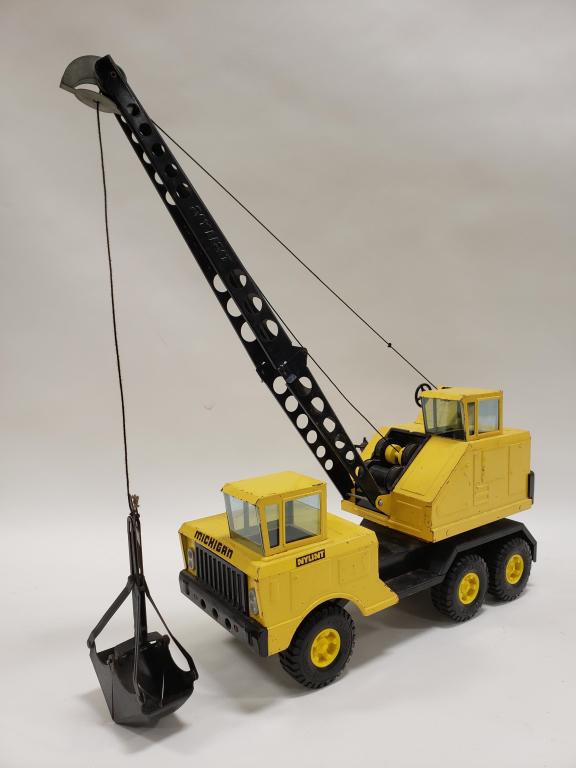 Nylint Michigan Crane Shovel Truck: Nylint Michigan crane shovel truck. Displays nicely with paint loss and wear from play and age. Both cranks work. The truck measures approximately 18" long.