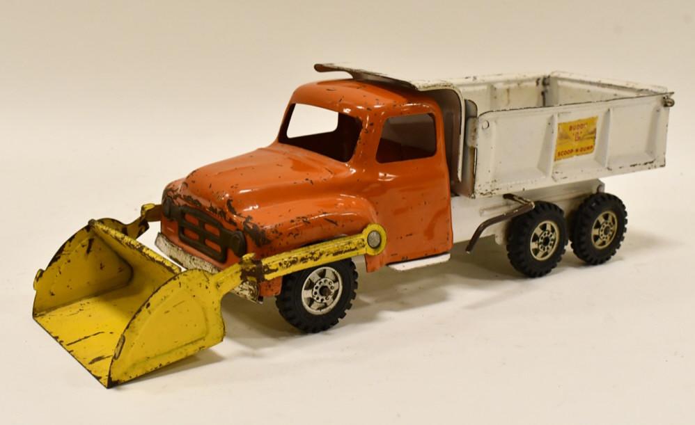 Buddy L Scoop-N-Dump Truck: Buddy L Scoop-N-Dump truck with scissor lift bed. The scissor lift works. Displays nicely with paint loss and wear from play and age. Measures approximately 18" long.