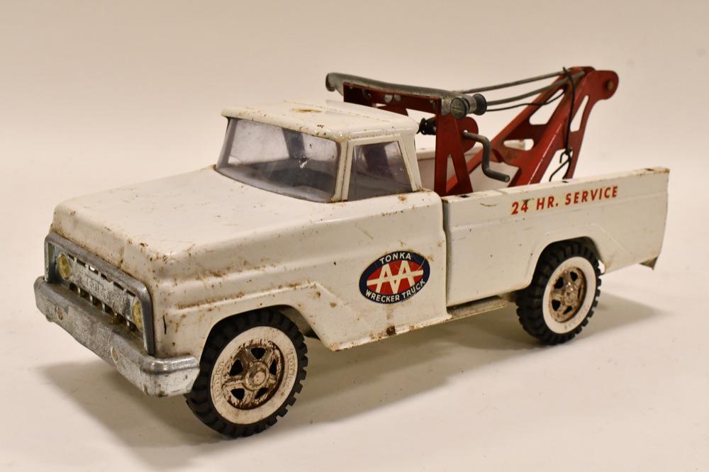 Tonka AA Wrecker 24 HR. Service Tow Truck: Tonka AA wrecker 24 hour service tow truck. It is missing the siren and light on the wrecker. Displays well with paint loss and wear from play and age. Measures approximately 14" long