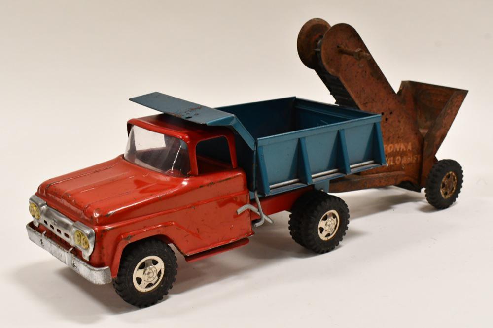Tonka Dump Truck with Sand Loader: Original Tonka dump truck with sand loader. Displays nicely with paint loss and wear from play and age. The sand loader has unoriginal replacement parts, rust, and is in need of a restoration. Dump tr