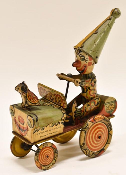 Unique Art Tin Litho Windup Unique Artie Clown Car: Unique Art Mfg. Co. tin itho windup Unique Artie The Clown Dipsy Car with his dizzy pup JoJo on the hood. The toy has paint loss and wear from play and age. Will need a good cleaning. Windup mechanism