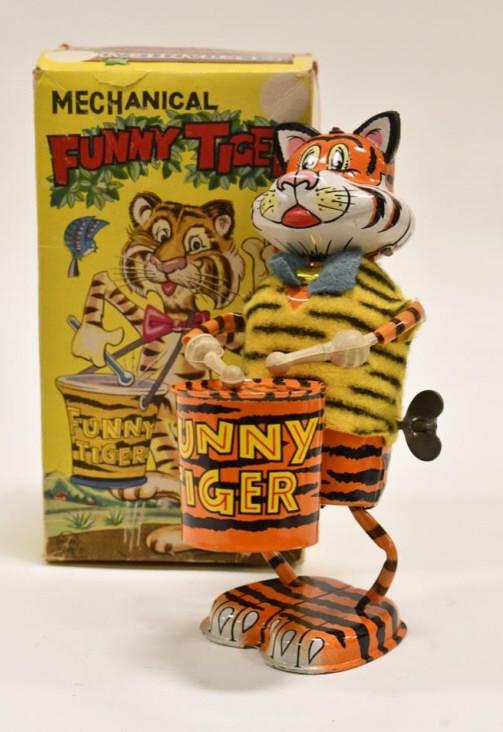 Marx Tin Windup Drumming Funny Tiger In Box: Marx tin litho windup drumming funny tiger with the original box. The box has some crushing and wear from storage. The windup works. Displays nicely. Measures approximately 8" tall.