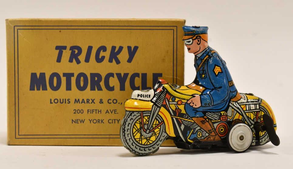 Marx Tin Litho Windup Tricky Police Motorcycle: Marx tin litho windup tricky police motorcycle with the box. The windup works. Displays well with some light wear from play and age. The box is straight with all the flaps. Measures approximately 4 1/