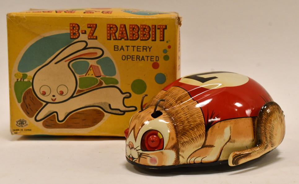 Modern Toys Tin Battery Op. B-Z Rabbit: Modern Toys tin battery operated B-Z Rabbit with box. Toy displays nicely with some wear from age and play. The rabbit is missing his ears. Battery compartment is clean. Measures approximately 6" long