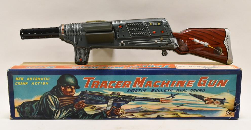 Sankei Japan Tin Litho Tracer Machine Gun: Sankei Japan tin litho tracer machine gun with box. Displays nicely with wear from play and age. Comes with some plastic bullets with rubber tips. Gun measures approximately 20 1/2" long.