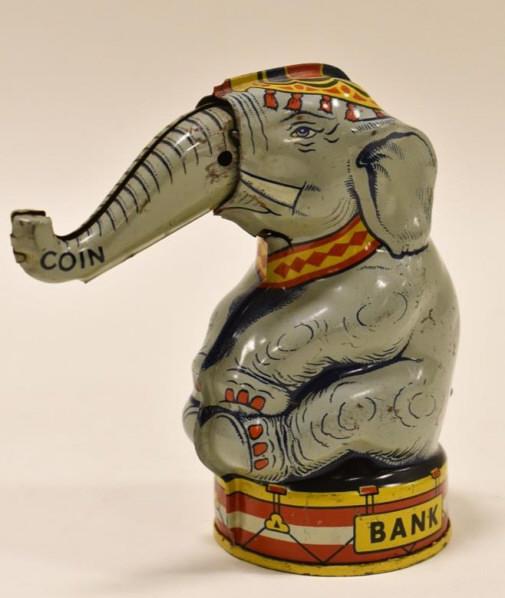J. Chein Tin Litho Mechanical Elephant Bank: J. Chein tin litho mechanical elephant bank. Displays well with some paint loss and wear from use and age. When you pull the lever it moves the elephant's trunk. Measures approximately 5 1/4" tall.