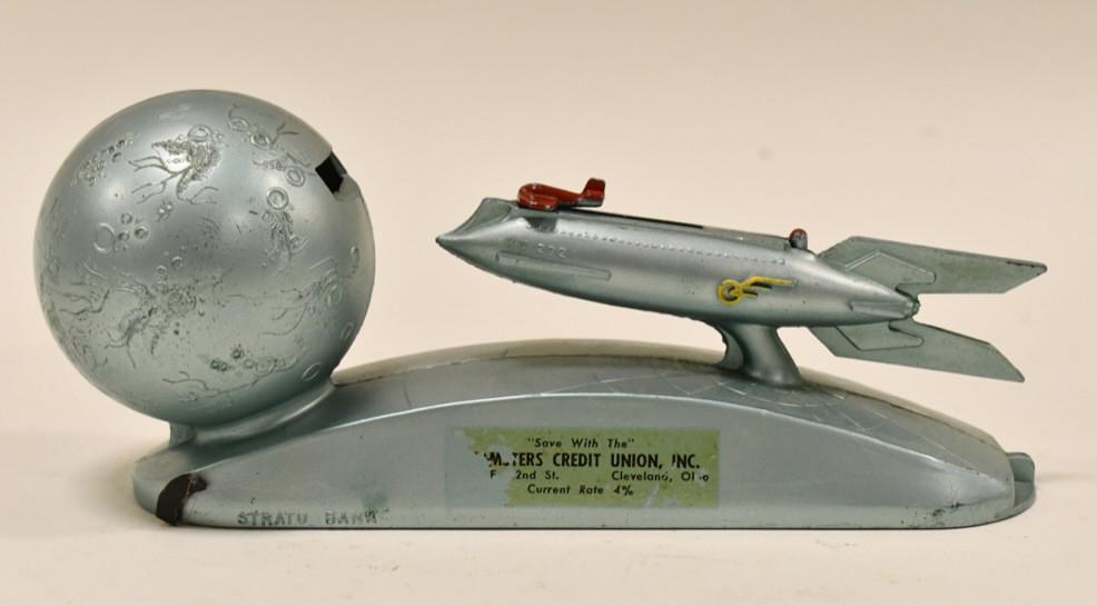 Strato XU-232 Rocket Ship Mechanical Coin Bank: Strato XU-232 rocket ship mechanical coin bank. Coin can be pulled back with the ship and can be shot at the moon. Nice working condition. Displays well with some wear from age and play. Measures appr