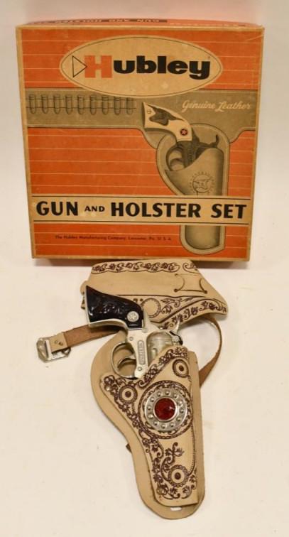 Hubley Western Cap Gun w/ Holster In Box: Hubley Western cap gun with leather holster in the box. The cap gun has some corrosion and wear from sitting in the holster. The trigger works. The box is in overall nice condition with some discolora