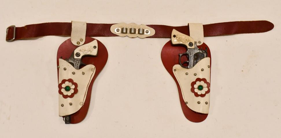 Wyandotte Red Ranger Jr. Cap Gun Set w/ Holster: Wyandotte Toys Red Ranger Jr. cap gun set with leather holster. The one trigger does not work, and the other one works but sticks. Both guns have corrosion and wear from use and age. The holster has a