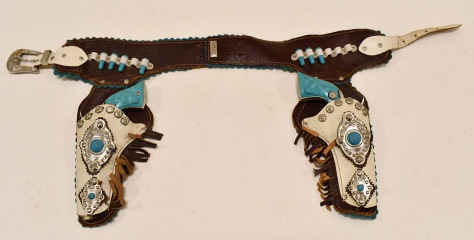 Long Island Inc. Texas Cap Gun Set w/ Holster: Long Island Die-Casting Inc. Texas cap gun set with leather holster. The cap guns display well with the turquoise grips. They have some corrosion and tarnish from use and age. The triggers work. The h