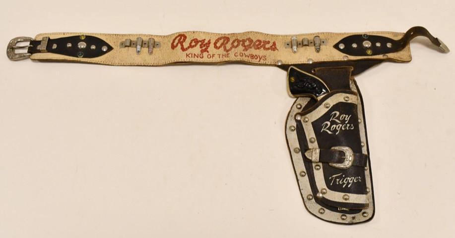 Gold Stevens Cowboy King Cap Gun w/ Holster: Gold Stevens Cowboy King cap gun with Roy Rogers & Trigger leather holster. The cap gun has some paint loss and wear from use and age. The holster has some cracking and loss of color. The trigger work
