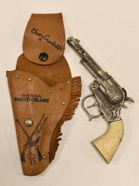 Leslie-Henry Davy Crockett Cap Gun Pistol Holster: Leslie-Henry Davy Crockett cap gun pistol with Davy Crocket holster. The trigger works. The cap gun has some corrosion and discoloration to the grip. Overall the set displays well. Gun measures approx