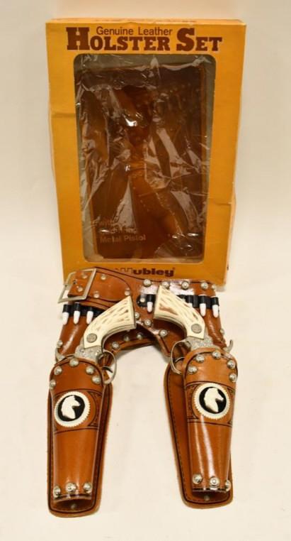 Hubley Texan Jr. Cap Gun Set w/ Holster In Box: Hubley Texan Jr. cap gun set with leather holster in the box. The holster has become stiff from age. The cap guns in nice condition with light wear from age and display. The triggers work. The plastic