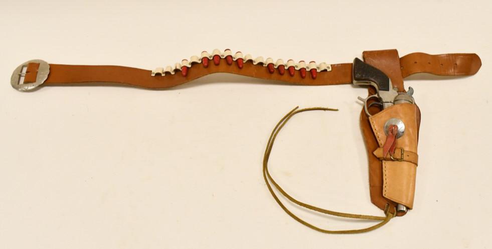 Geo. Schmidt Buck'N Bronc BB-Marshal Cap Gun: Geo. Schmidt Buck'N Bronc BB-Marshal cap gun with single holster. The cap gun is in good condition with some corrosion and wear from age. The holster has wear from use and age. The trigger works. Gun 