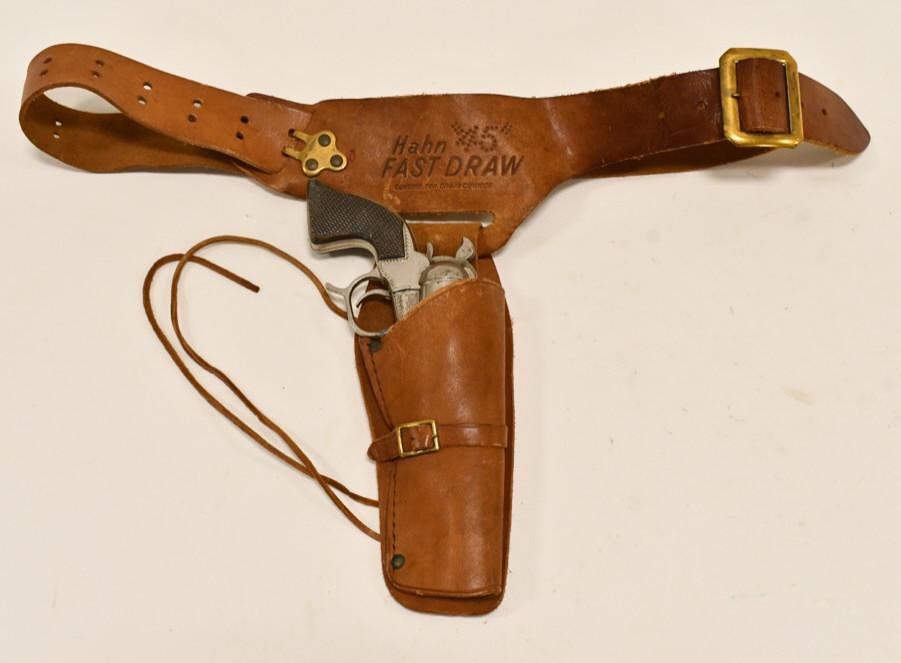 Hubley Patrol Cap Gun w/ Hahn Fast Draw Holster: Hubley Patrol cap gun with Hahn Fast Draw leather holster. The trigger works, but the gun does not stay latched. The holdter displays well with some cracking of the leather from use and age. Gun measu