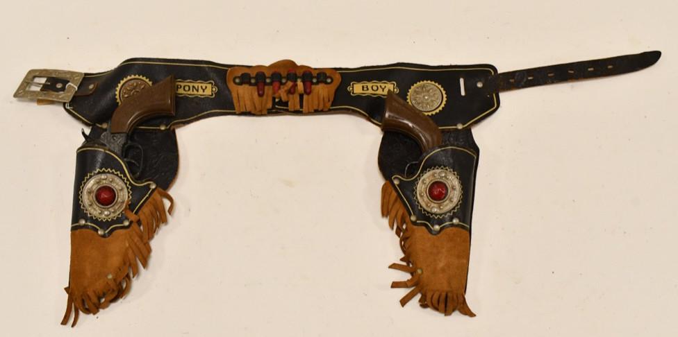 Hubley Pony Boy Cap Guns w/ Leather Holster: Hubley Pony Boy cap guns with Pony Boy leather holster. The guns have some corrosion and wear from use and age. The triggers work. The leather holster has some cracking and wear from age. Each gun mea