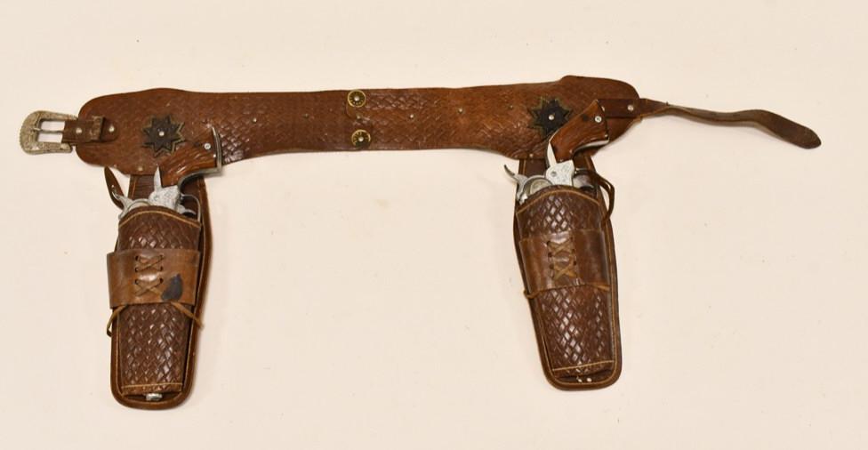 Halco Marshall Cap Gun Set w/ Leather Holster: Halco Marshall cap gun set with leather holster. The cap guns need to be oiled, the triggers work, but stick. The cylinders do not work. The guns have corrosion and wear from use and age. They are bot