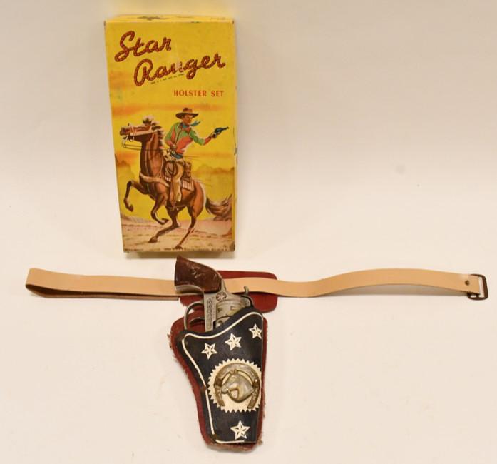 Star Ranger Holster Set w/ Hubley Cowboy Cap Gun: Star Ranger holster set with Hubley Cowboy cap gun pistol. The cap gun has corrosion and wear from use and age. The trigger works. The holster has some rust and corrosion on the rivets. The box displa