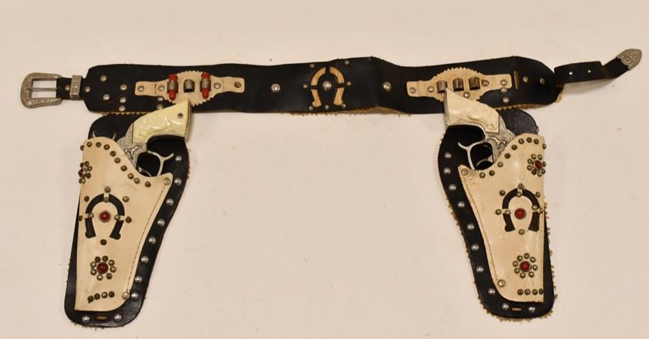 Leslie-Henry Champion Cap Gun Pistol w/ Holster: Leslie-Henry Champion cap gun pistol with holster. The cap guns have corrosion and wear from use and age. The triggers work. The holster has wear from use and age. Gun measures approximately 9" long.