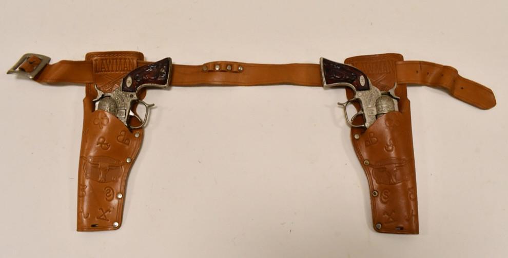 Halco U.S. Marshal Cap Gun Set w/ Lawman Holster: Halco U.S. Marshal cap gun set with Lawman leather holster. The cap guns have corrosion and wear from use and age. The triggers work, but the cylinders do not. The holster is in overall good condition