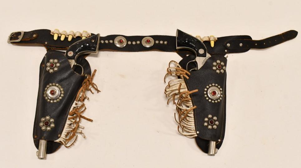 Hubley Cowboy Cap Gun Set w/ Leather Holster: Hubley Cowboy cap gun set with leather holster. The leather holster has some cracking and general wear from use and age. The cap guns have some tarnish and corrosion from age. The triggers work, but t