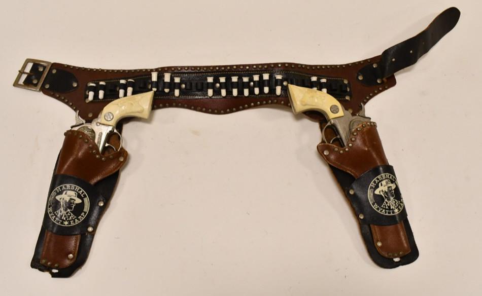 Hubley Marshal Cap Gun Set w/ Wyatt Earp Holster: Hubley Marshal cap gun set with Wyatt Earp Marshal leather holster. The triggers work. The cap guns have corrosion and wear. The leather holster is in nice condition, but has become stiff from age. Ea