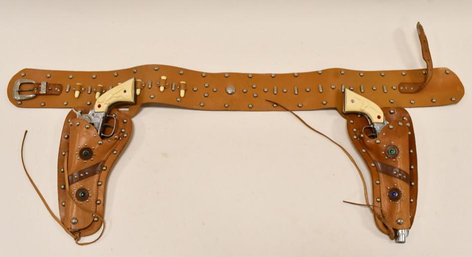 Nichols Stallion 45 Cap Gun Set w/ Leather Holster: Nichols Stallion 45 cap gun set with leather holster. The triggers work on the cap guns, but the cylinders don't work. The one trigger sticks. The cap guns have some corrosion and wear from use and ag