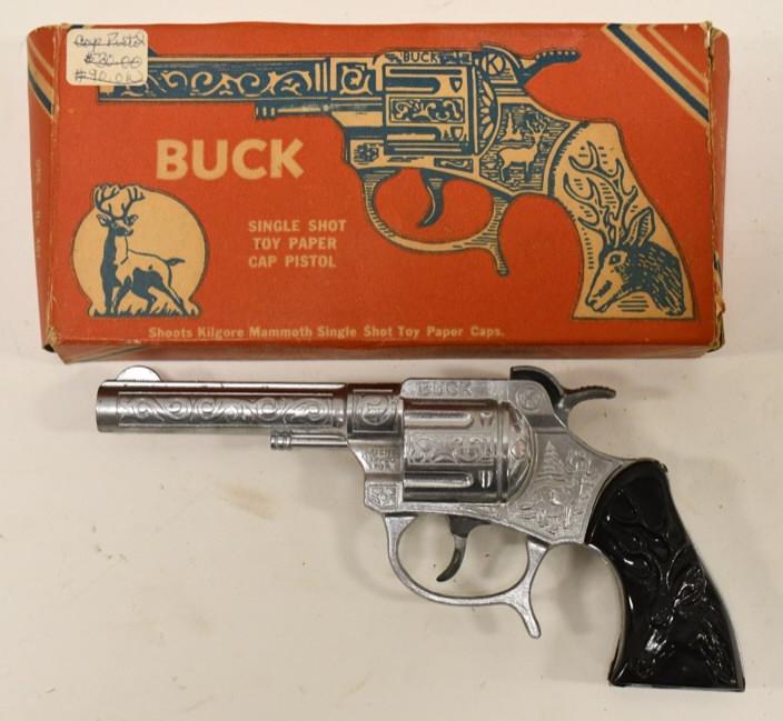 Kilgore Buck Single Shot Paper Cap Pistol w/ Box: Kilgore Buck single shot toy paper cap pistol with the original box. The gun is in nice condition with light wear from age. The box is missing one small flap. Gun measures approximately 6 3/4" long.