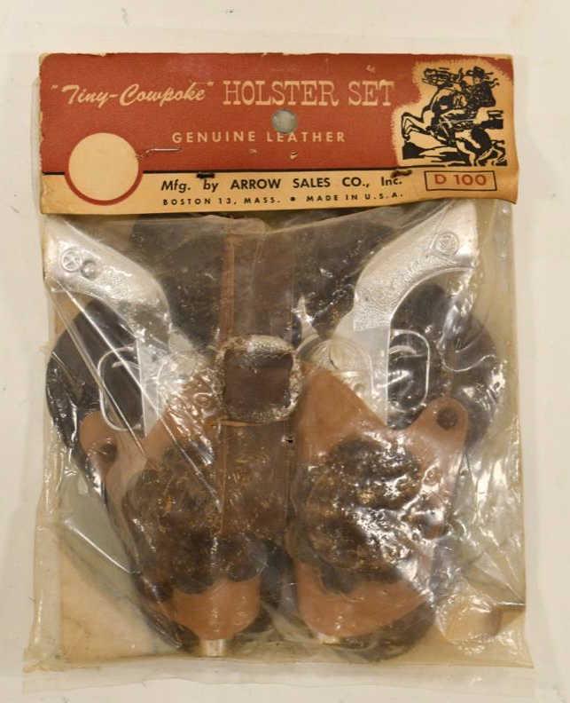 Arrow Sales Tiny Kilgore Pal Cap Gun Holster Set: Arrow Sales Co. tiny Kilgore Pal cap gun holster set in the package. The package appears to have been opened at one time. The cap guns have some corrosion and wear from age. Set displays nicely in the
