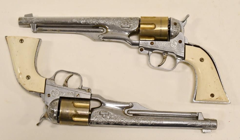 Set Of Hubley Colt .45 Cap Gun Pistols: Set of Hubley Colt .45 cap gun pistols. The triggers work, but the cylinders do not revolve. They have some corrosion and wear from age. The grips have some chips and scratches. Overall the set displa