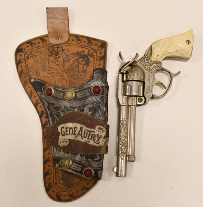 Buzz Henry Gene Autry Cap Gun Pistol: Buzz Henry Gene Autry cap gun pistol. Does have some touch ups and wear from use and age. Comes with a jeweled single Gene Autry holster. Gun measures approximately 9" long.