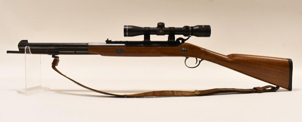 Thompson Center White Mountain .50 Muzzleloader: Thompson Center Arms White Mountain black powder carbine in .50 caliber. The muzzleloader is in nice condition with some light use wear and has a 21" barrrel, ramrod, Tasco scope, and leather sling. S
