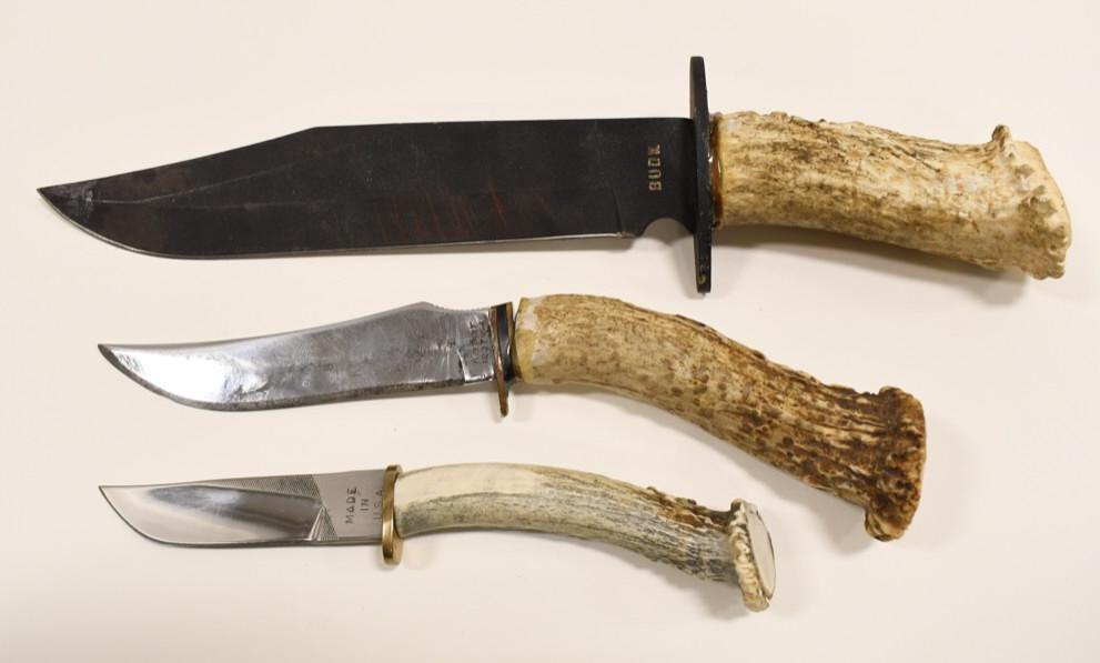 (3) Custom Vintage Stag Handle Fixed Blade Knives: Lot of three vintage custom stag handled fixed blade hunting knives. They vary in age and condition with wear from use and age. They are marked "Budk BK927", " Kabar 1237", and Savage. All display wel