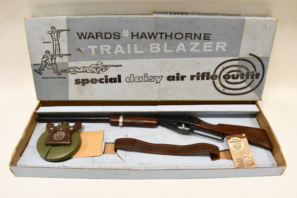Daisy Montgomery Ward Model 80 BB Rifle Set: Wards Hawthorne Trail Blazer Special Daisy Air Rifle Outfit. Set includes a Daisy Model 80 BB Long Rifle, Belt, and Canteen. Set is not new, but comes in box. Rifle has warping to the plastic stock an