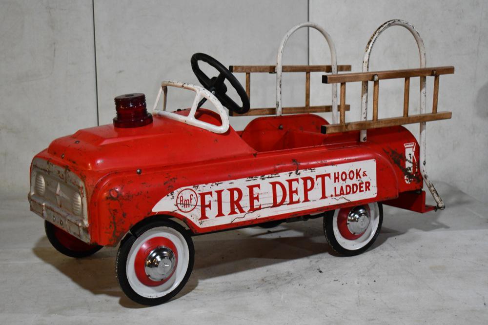 AMF Fire Dept. Hook and Ladder Pedal Car: AMF Fire Dept. Hook and Ladder Pedal Car. Overall nice condition with some paint loss and wear from age and display. Hub caps and ladders have been replaced. Measures approximately 40"long.