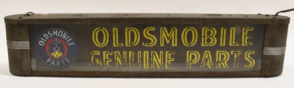 Early Oldsmobile Dealership Glass Lighted Adv Sign: Scarce early Art Deco Oldsmobile Genuine Parts dealership reverse on ribbed glass lighted advertising sign. Sign is in fair condition with paint loss on reverse glass, surface rust on can, appears to