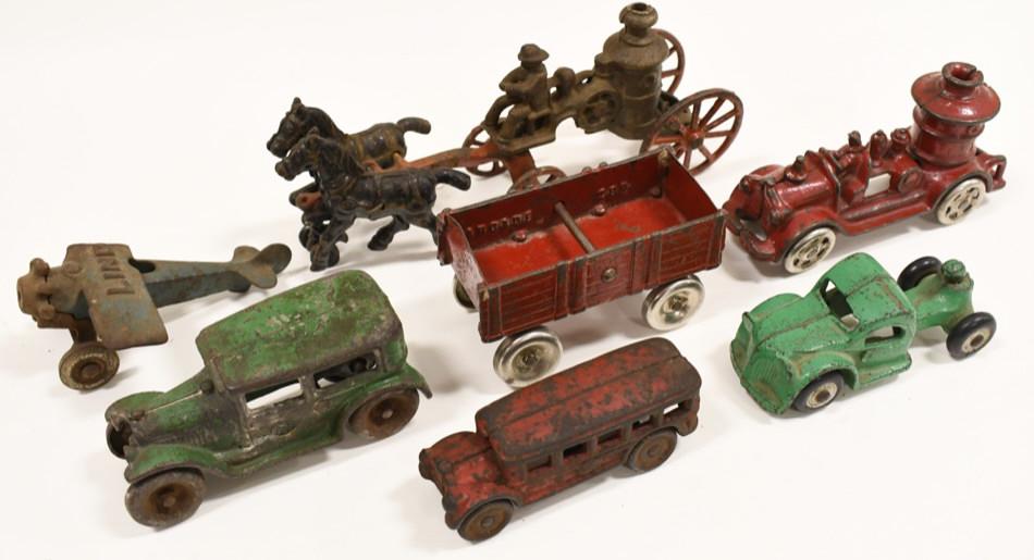 Lot Of Early Cast Iron Arcade Toy Cars & More: Lot of early cast iron Arcade toy cars and more. Lot includes an Arcade No.114 green coupe, Arcade no. 299 wagon , Arcade no. 321 bus cab, small bus marked no. 13 , Hubley Lindy plane with damaged win