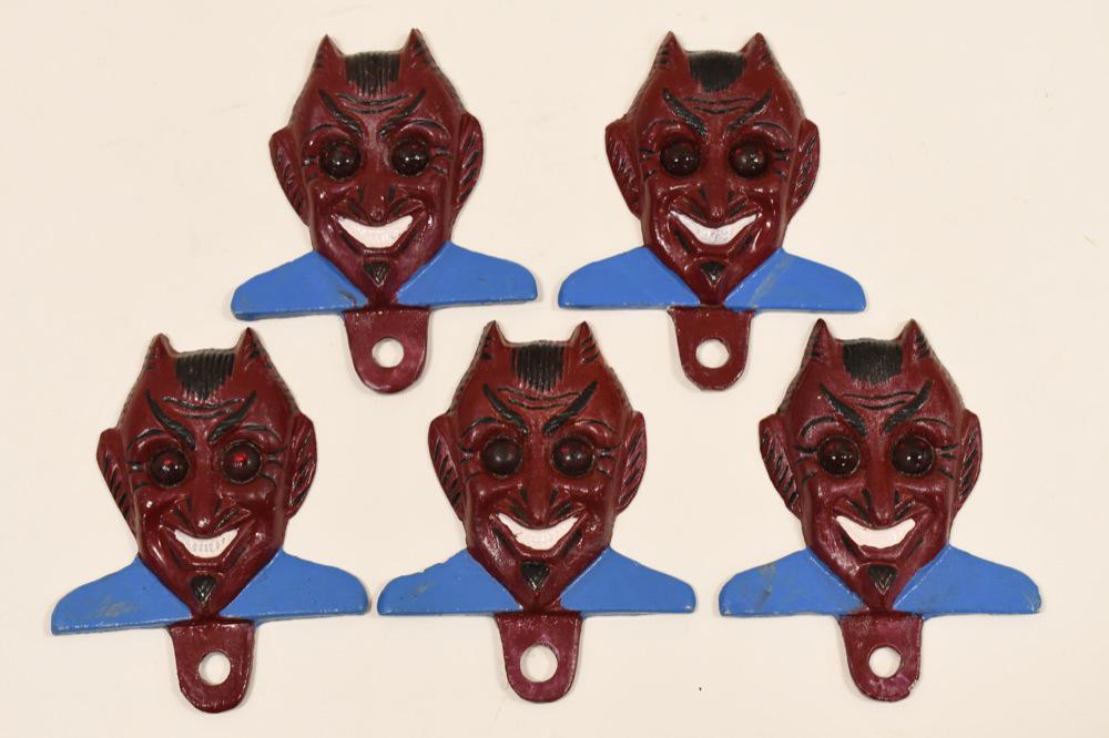 5 Cast Metal Glass Eye Devil License Plate Toppers: Lot of five cast metal devil license plate toppers with red glass marble eyes. Good condition with some paint loss and wear from use. They measure approximately 4-1/4" tall.