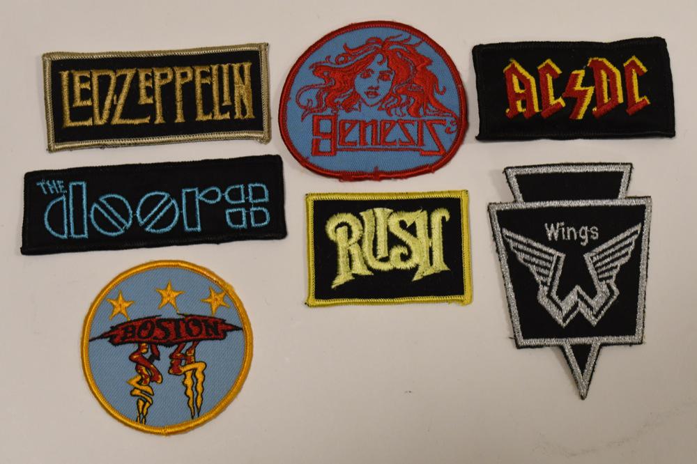 Lot OF 7 Vintage Rock And Roll Embroidered Patches: Lot of seven vintage Rock and Roll embroidered iron on patches. Lot includes Led Zeppelin, Genesis, AC/DC, Rush, Wings, The Doors, and Boston. They are all in good condition woith some wear from age a