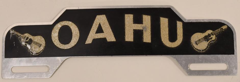 Vintage OAHU Reflective License Plate Topper: Vintage OAHU reflective license plate topper by Advertising Plates Co. Good condition with paint loss and wear from use and age. Displays well. Measures approximately 10-1/4" across.