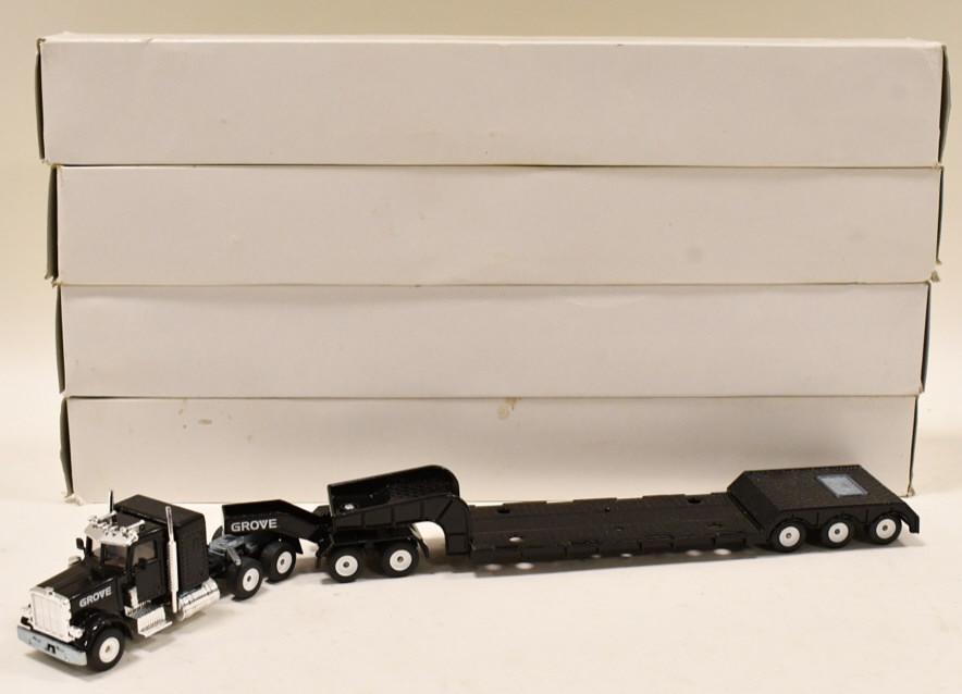 (4) 1/50 Siku Grove Peterbilt Trucks w/ Lowboys: (4) 1/50 scale Siku Grove Peterbilt trucks with lowboy trailers. Good condition in the boxes.