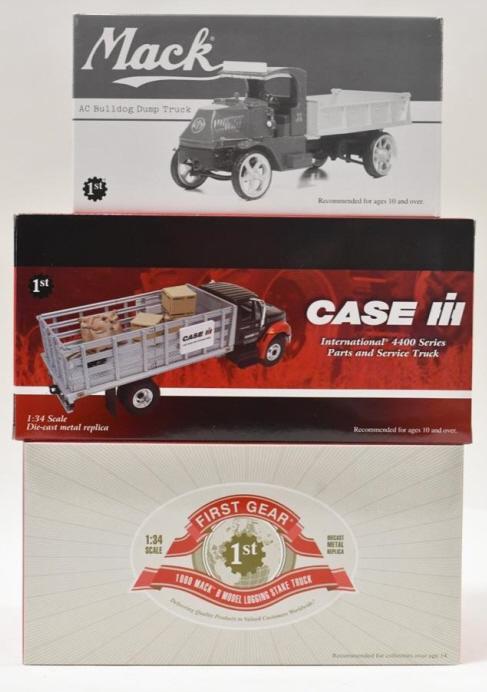 1/34 Mack Bulldog & International Service Truck: 1/34 scale 1st Gear Mack AC Bulldog dump truck, Case IH International 4400 series parts and service truck, 1960 Mack B Model logging stake truck. Good condition in the boxes.