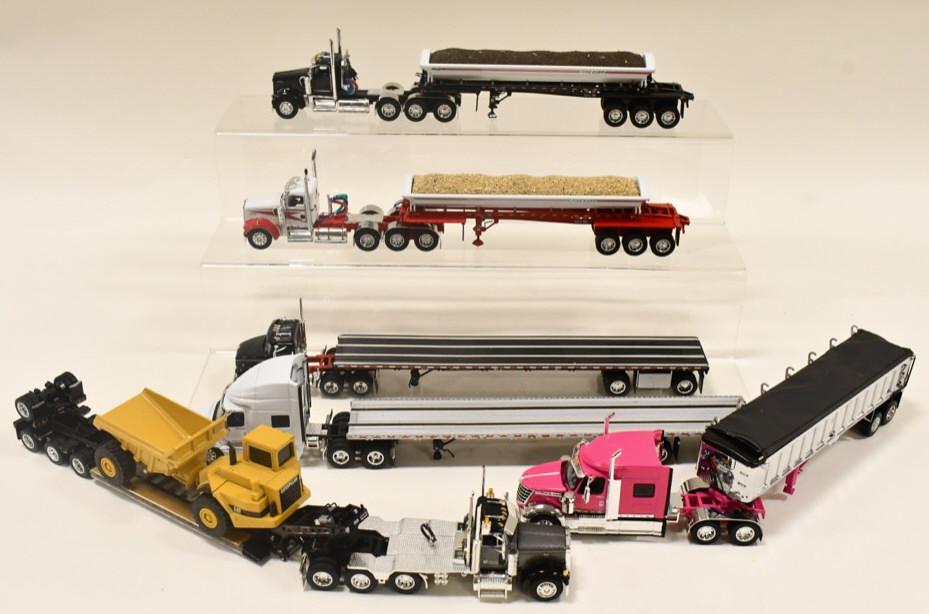 1/64 DCP Peterbilt, Kenworth, International Trucks: 1/64 scale Die-Cast Promotions Peterbilt, Kenworth, and International trucks and trailers. Includes dump trailers, flatbeds, and lowboys. Some have loose or broken pieces.